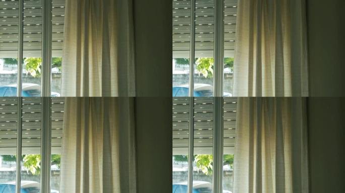 窗帘随风在窗户里移动。放大镜头。