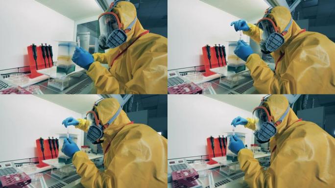 一个穿着危险品的人在实验室里用冠状病毒抗体工作。
