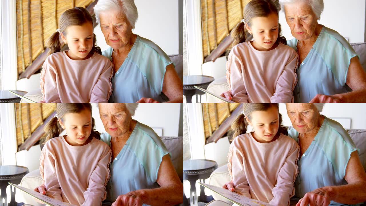 高加索祖母和孙女看相册4k的前视图