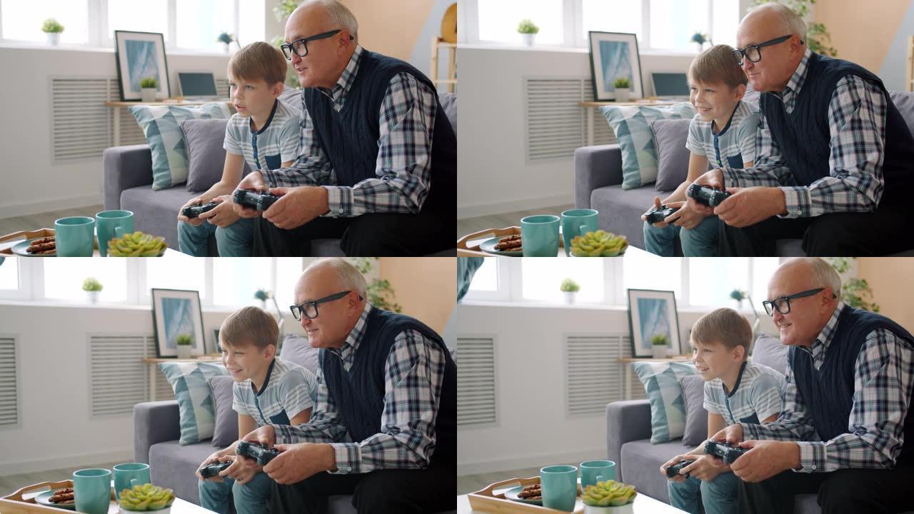 老人玩电子游戏与快乐的孩子孙子在家里玩得开心