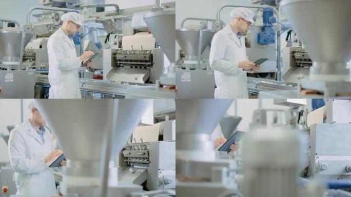 年轻的男性质量主管或食品技术员正在饺子食品工厂检查自动化生产。员工使用平板电脑工作。他戴着白色的卫生