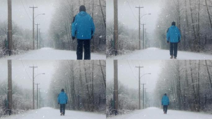 男子在雪地上行走雪天行走下雪天