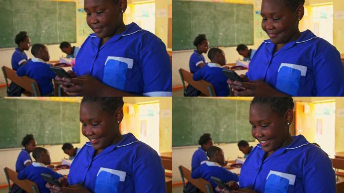 在乡镇学校的教室里使用智能手机的女学生4k