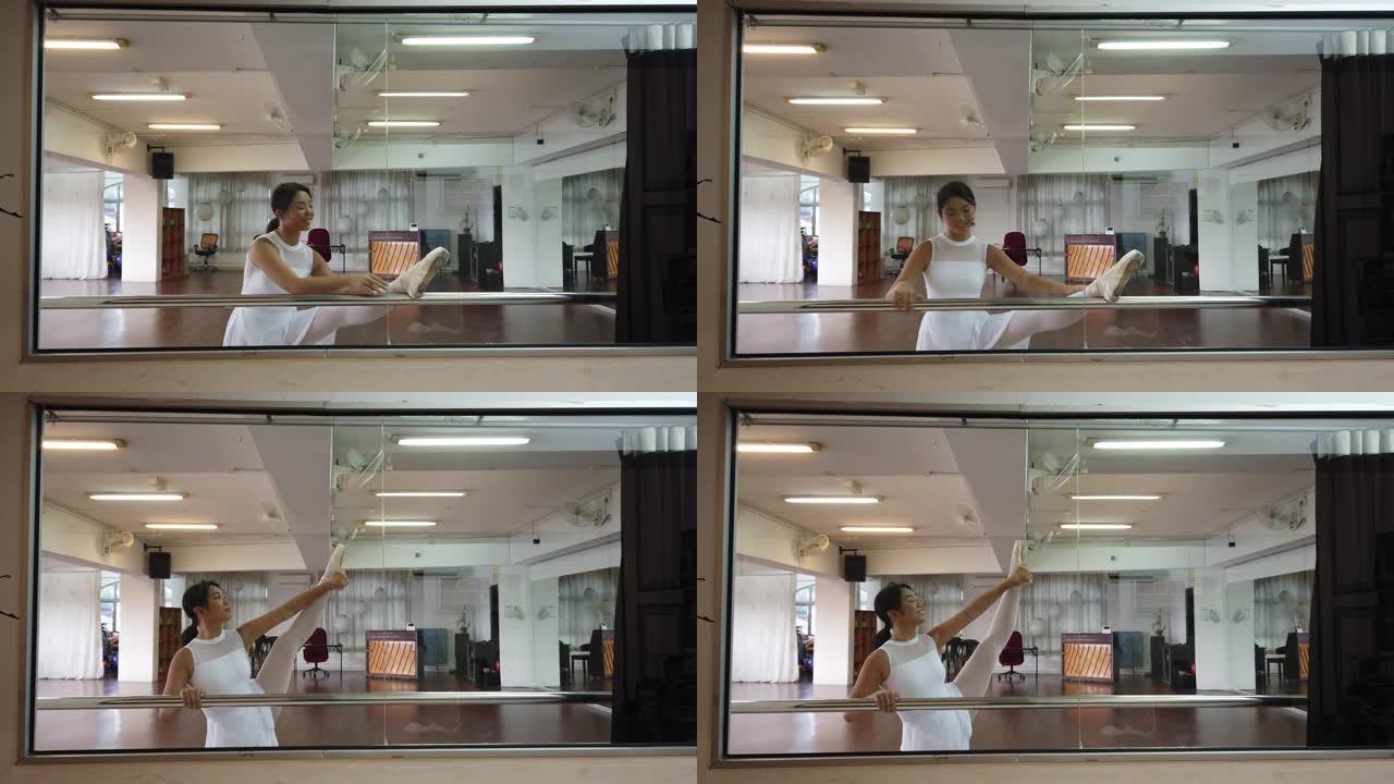 一名亚洲华裔女芭蕾舞演员在舞蹈工作室练习并做好准备