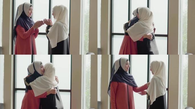慢动作: 穆斯林妇女问候她的朋友并微笑着交谈