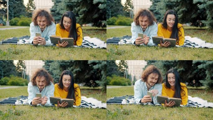 男人和女人在公园里使用智能手机和看书聊天放松