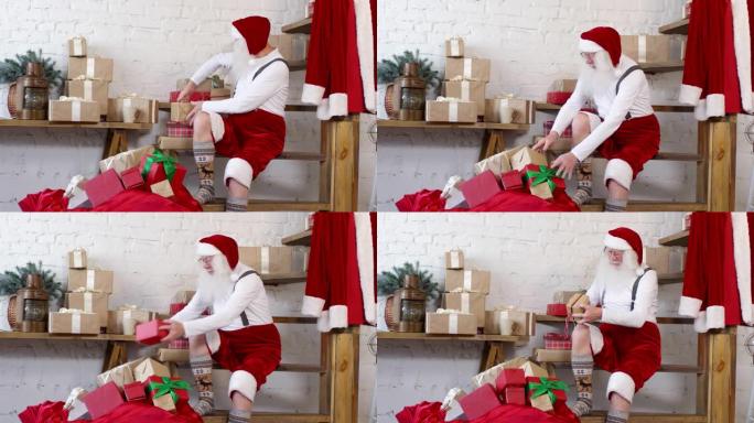 圣诞老人在家把圣诞礼物装进麻袋