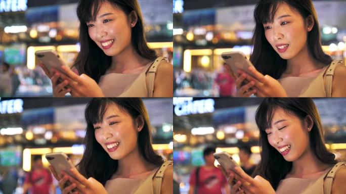 亚洲女性晚上使用智能手机