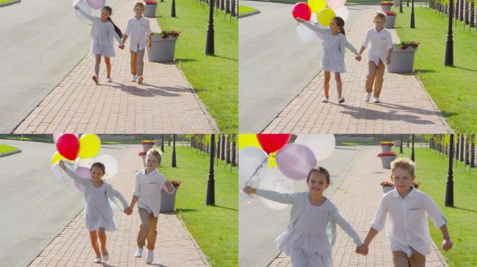 小孩手牵着手，带着气球奔跑