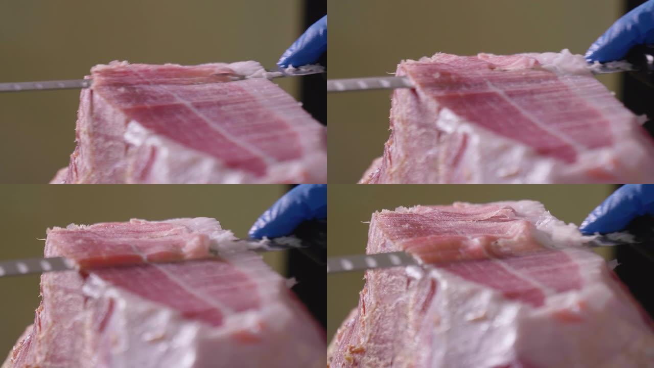 根据传统，用刀切出一块优质火腿的厨师的特写镜头。