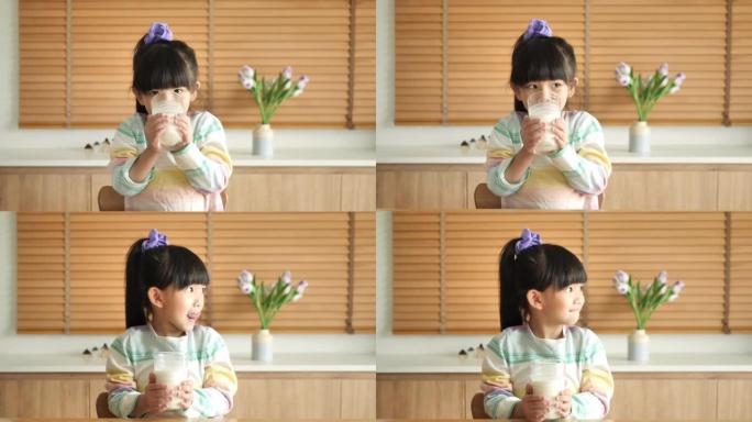 小女孩在家喝牛奶。
