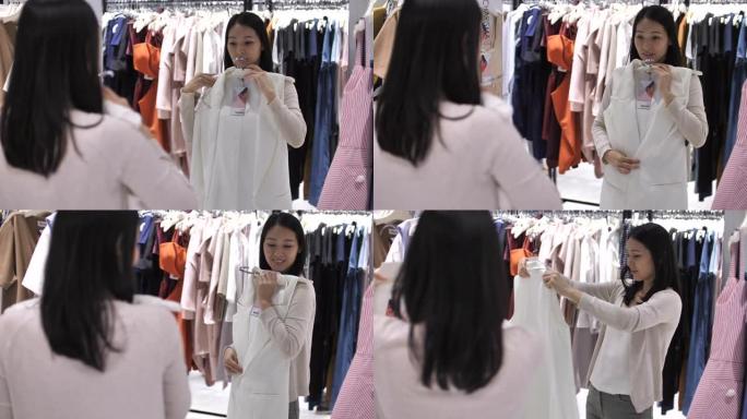 亚洲妇女在服装店试穿衣服购物衣服
