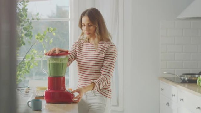 美丽的年轻女性在搅拌机中准备健康的绿色冰沙。正宗的时尚厨房配健康蔬菜。有机农业生产的天然清洁产品用于