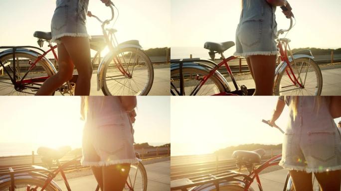 日落时木板路上的女孩步行沙滩巡洋舰自行车，镜头耀斑