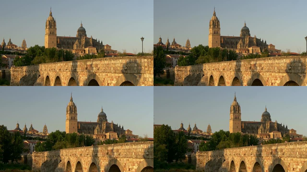 日落时萨拉曼卡大教堂和老桥。西班牙卡斯蒂利亚和莱昂。平移镜头，4K