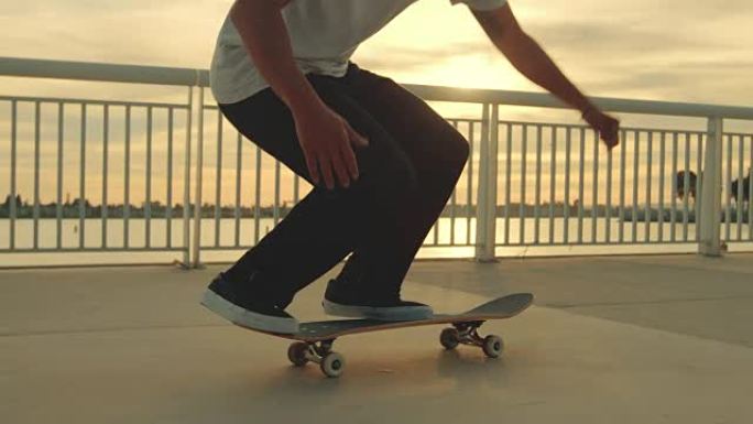 滑板手在日落时用镜头耀斑做极端翻转把戏