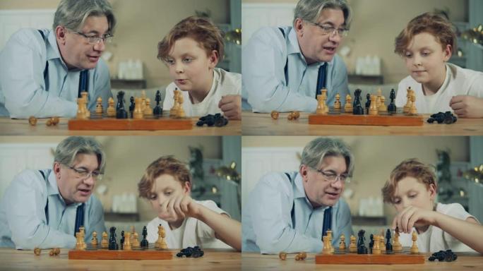 老人和他的孙子正在仔细观察棋子