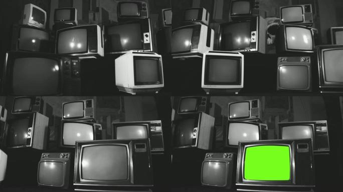 复古电视在许多电视中间打开绿色屏幕。黑白色调。