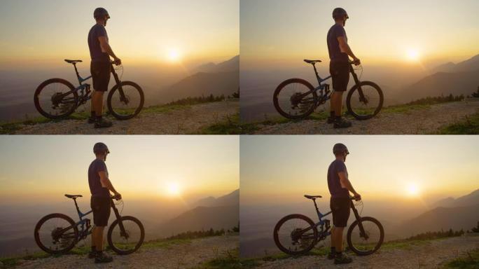 复制空间: 无法识别的人在骑山地自行车之前观看日出。