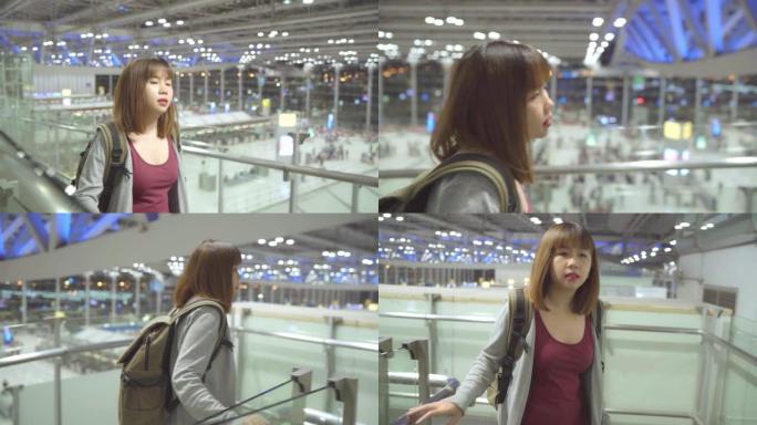 慢动作 -- 年轻的亚洲背包客女子在国际机场散步。