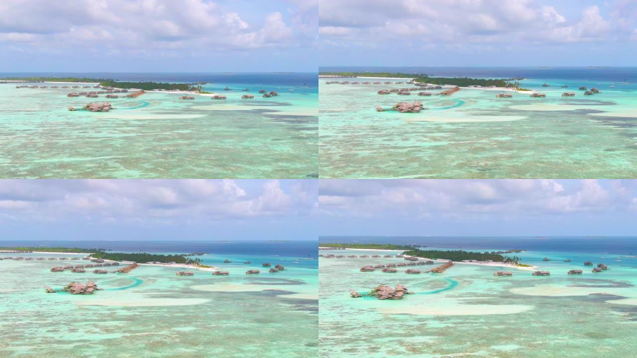 空中: 带着废弃的水上别墅飞向马尔代夫的一个岛屿。