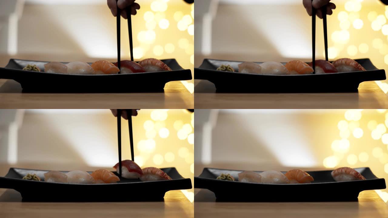 用筷子吃寿司的特写镜头。