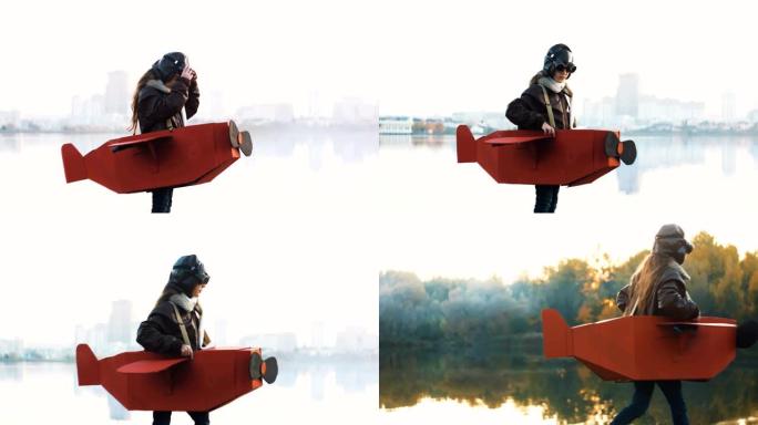 快乐的小飞行员女孩站在神奇的湖城全景玩纸板飞机上的飞行员，慢动作。