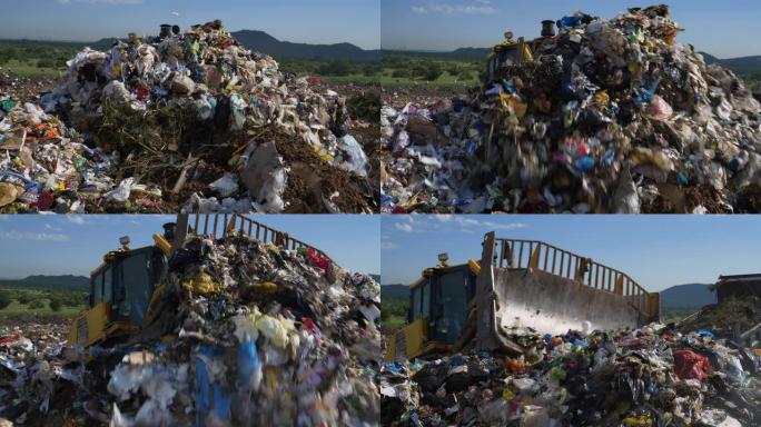 4k推土机在垃圾填埋场上搅动大量垃圾的特写视图