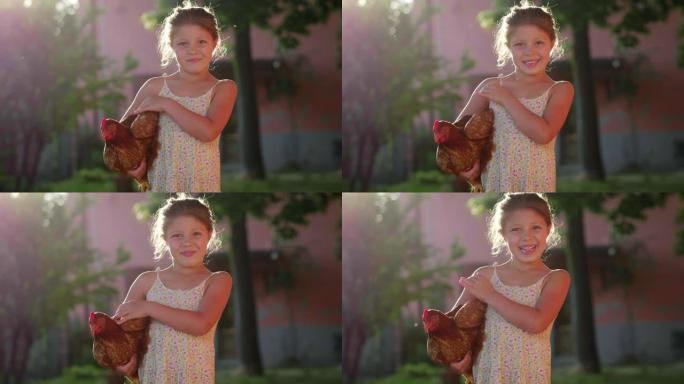 快乐的微笑小女孩的真实时刻在乡村房屋外抱着一只棕色的母鸡