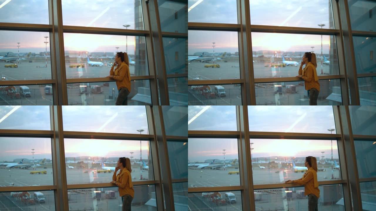 一名妇女正来到机场窗口并观察现场