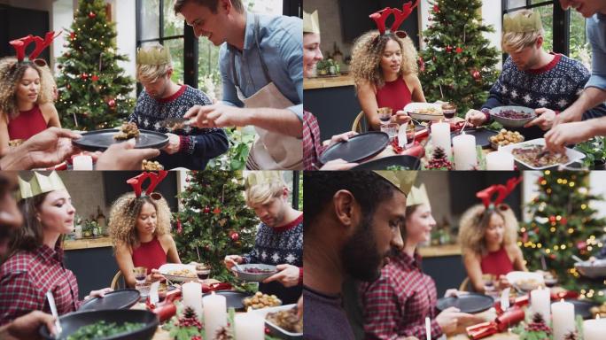 供应素食圣诞晚餐时，一群朋友坐在家里的餐桌旁