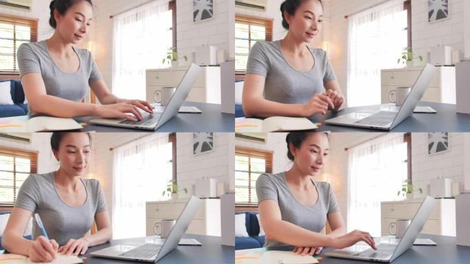 穿着休闲服装的亚洲美女使用笔记本电脑工作。在家工作，远程工作和自我隔离。新的家庭办公室设置