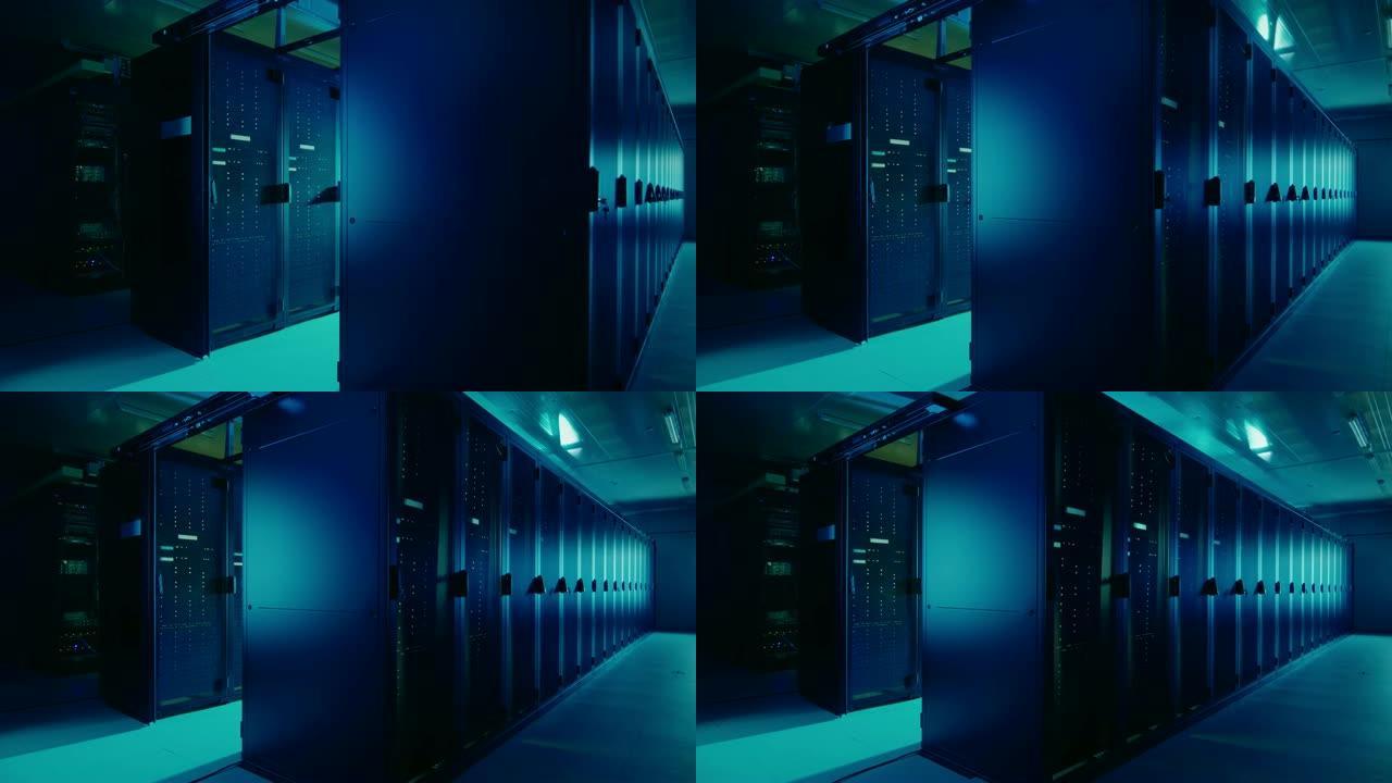 带有机架服务器行的工作数据中心的相机滑槽拍摄。Led灯闪烁，计算机正在工作。黑暗的环境光。绿色阴影。