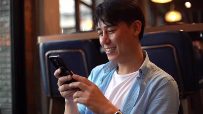 亚洲年轻人在餐厅使用智能手机