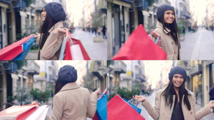 一个年轻漂亮的女孩喜欢在城市商店购物的同时购物。这个女孩拿着许多彩色的手提包。