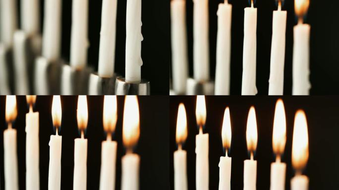 倾斜拍摄点燃的白色蜡烛燃烧在犹太烛台，选择性聚焦，近距离细节