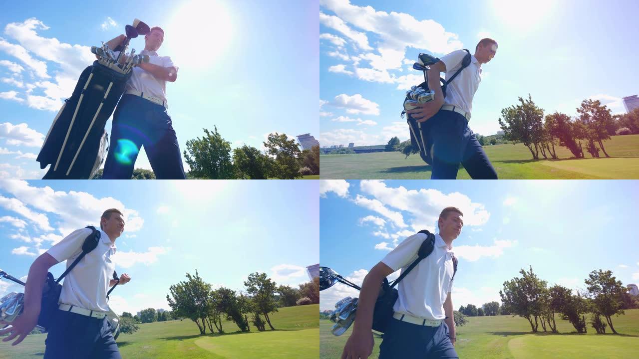 一个人拿着一个装有球杆的袋子，在高尔夫球场上散步。