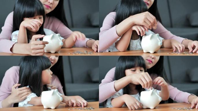 母亲在教女儿如何省钱。家庭存钱存钱罐。孩子生活中的一天