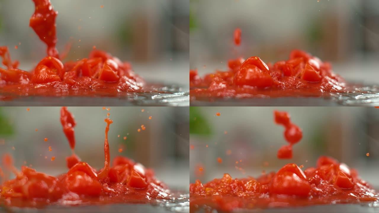 宏观: 切碎的樱桃番茄在黑盘上变成煮熟的番茄酱。
