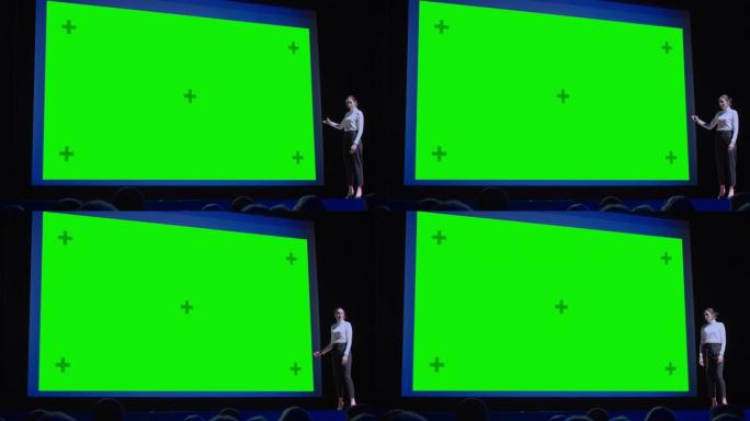 商务会议舞台: 女主讲人向观众展示新产品，在她的电影院后面，绿屏，模型，色键。现场活动，技术设备显示