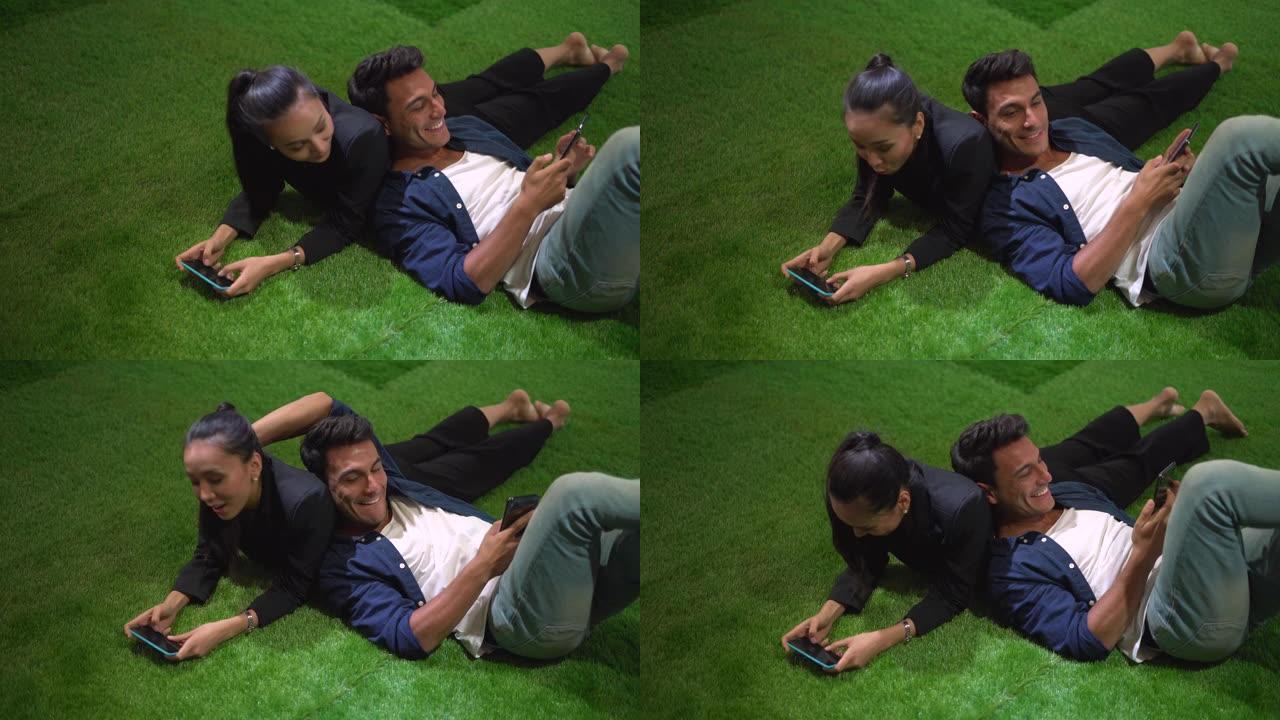 年轻夫妇在绿色地毯上放松