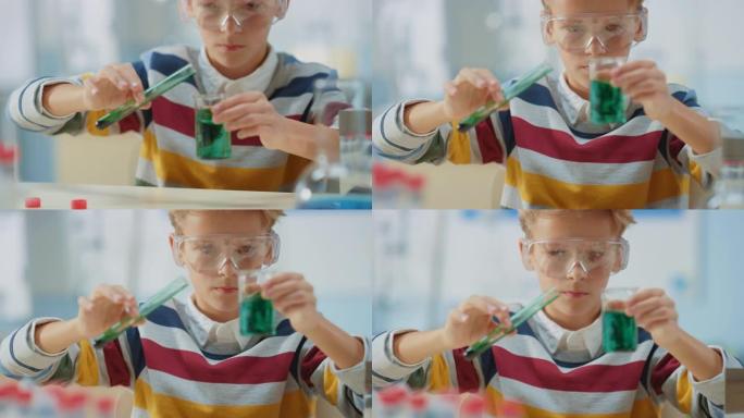 小学科学教室: 戴着安全眼镜的聪明小男孩在烧杯中混合化学物质