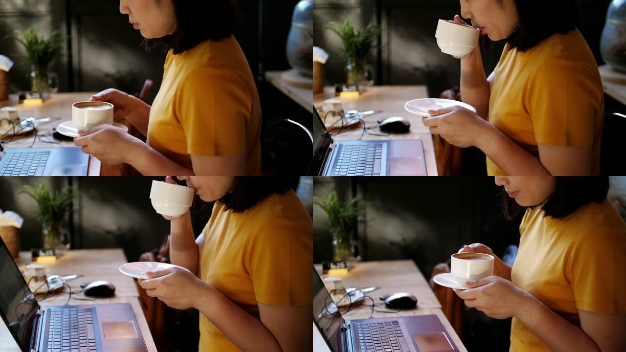女人用笔记本电脑工作，喝咖啡，慢动作