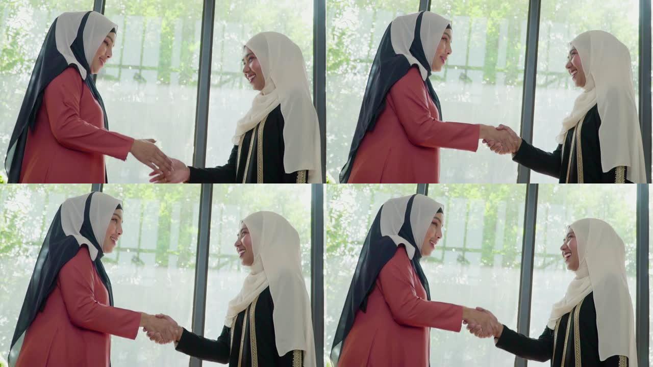 慢动作: 穆斯林妇女与朋友握手。