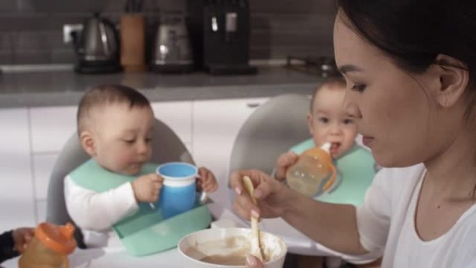 菲律宾妈妈耐心地喂养她1岁的三胞胎