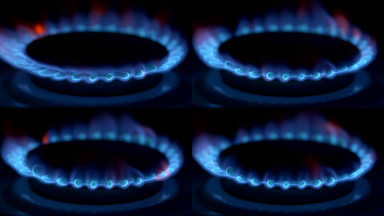 煤气炉在黑暗中燃烧着蓝色的火焰。UHD
