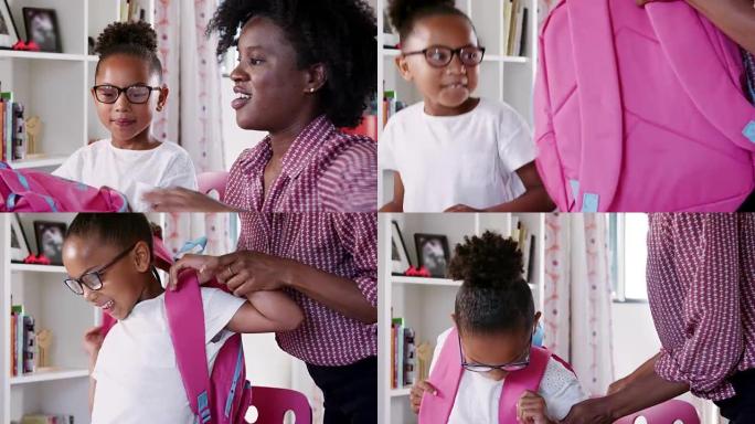 母亲在家里的卧室里帮助女儿打包书包-慢动作拍摄