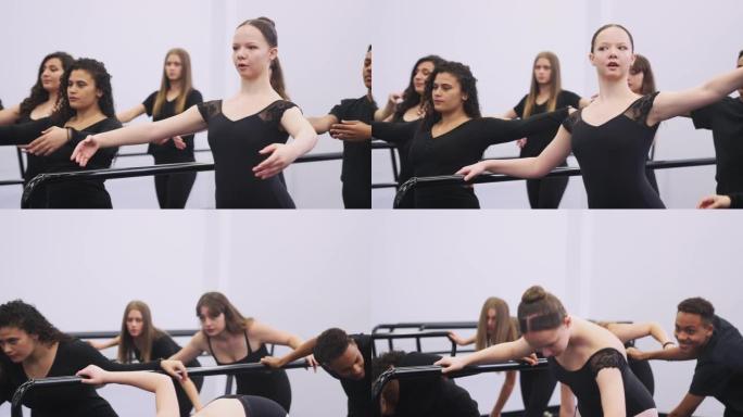 表演艺术学校的男女学生使用Barre在舞蹈工作室排练芭蕾舞