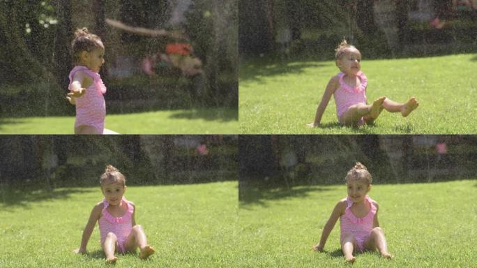 一个小女孩在花园里玩水，两个女孩奔跑，淋湿并大笑。概念: 家庭、爱情、乐趣和幸福。