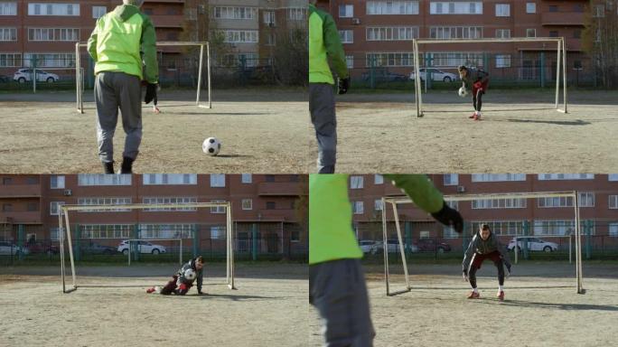 守门员在户外场地训练时捕捉足球